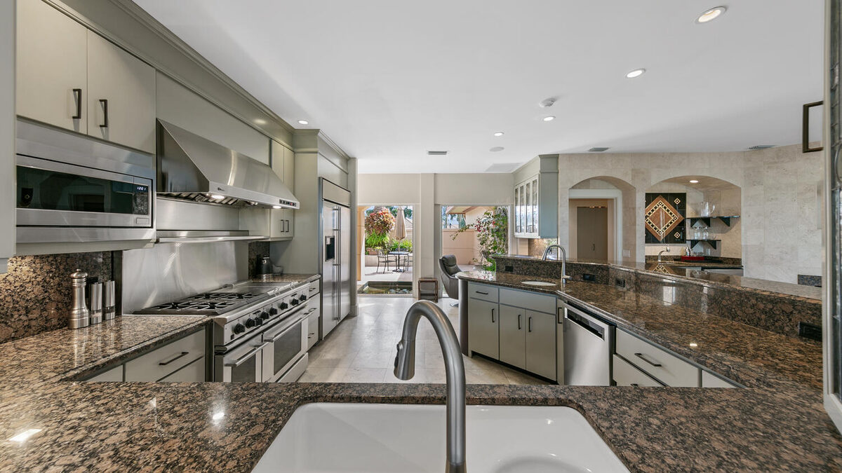 Kitchen with professional range and granite counters