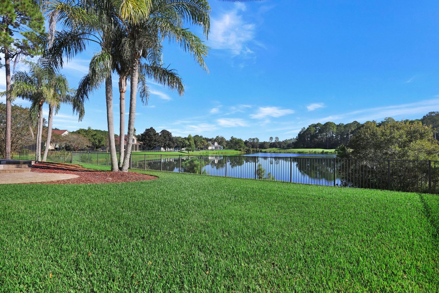 237 S Hampton Club Way — the fenced backyard and the lake