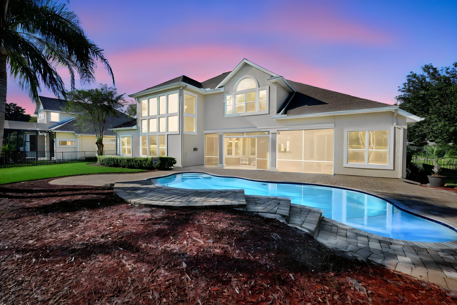 237 S Hampton Club Way, St. Augustine, FL 32092 &mdash; the two-story wall of glass and the pool at dusk