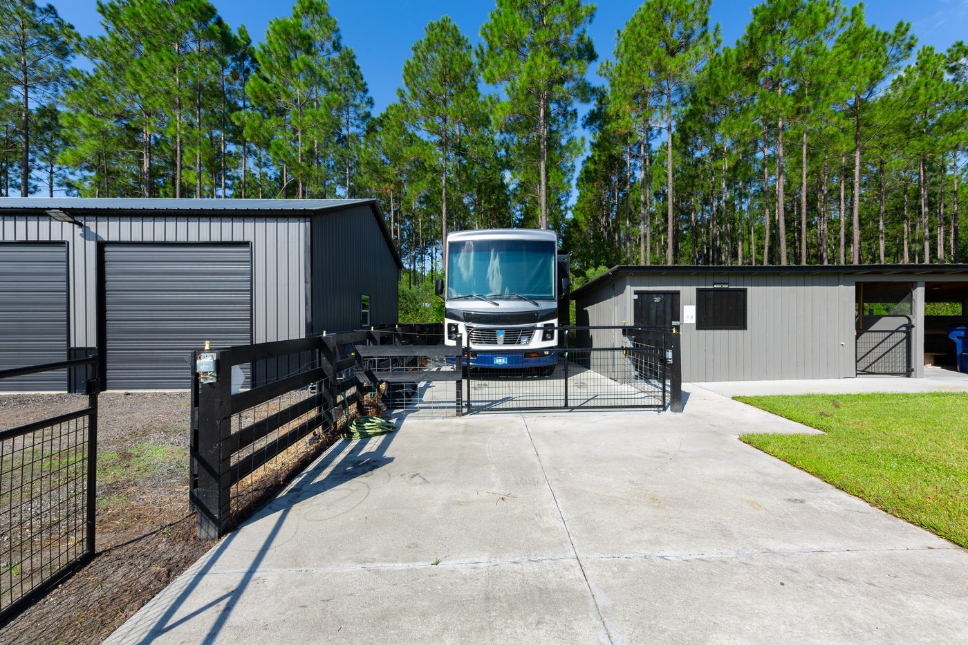 56057 Griffin Road &mdash; the RV parking between the barn and the carport