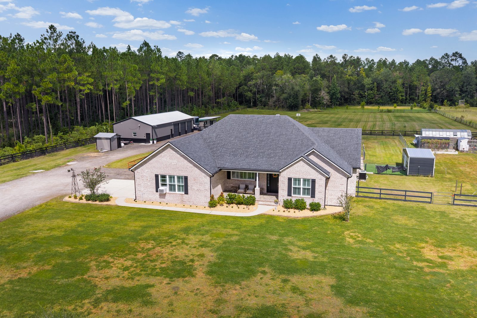 56057 Griffin Road, Callahan, FL 32011 &mdash; the house, the barndominium and the pastures from the air