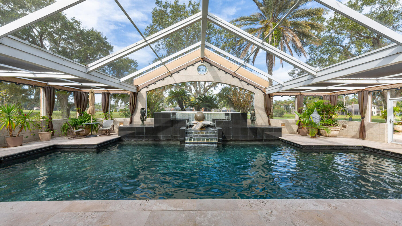 Screen-enclosed lap pool running the depth of the house