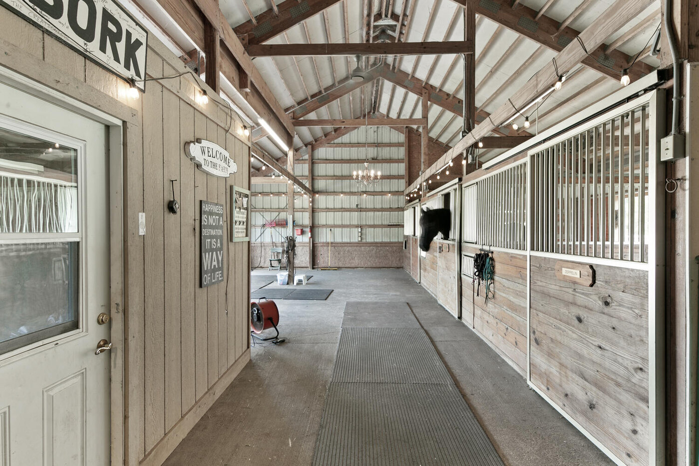 10680 Quail Ridge Drive — the barn aisle and the stalls