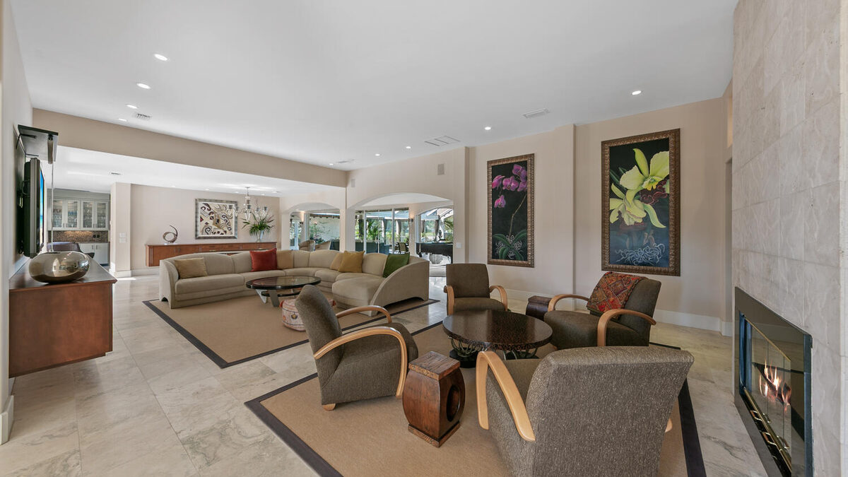 Living room with fireplace and travertine floors